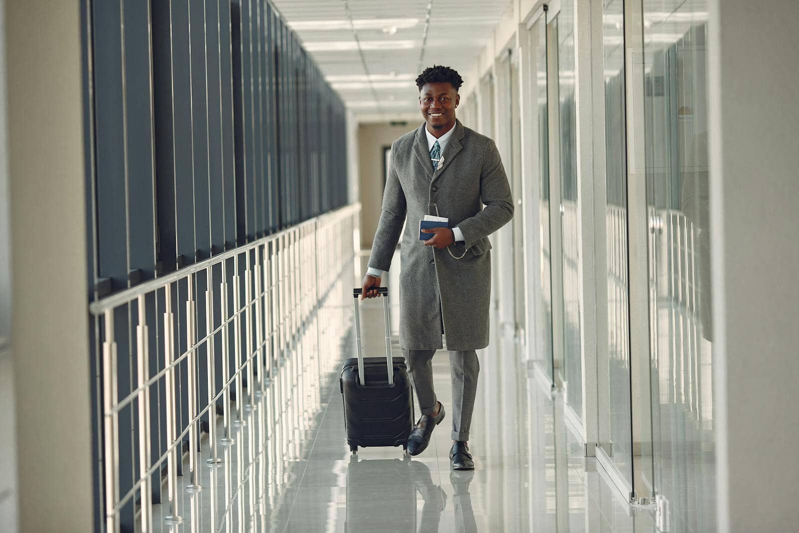 Business traveler walking with a carry-on suitcase before check-in