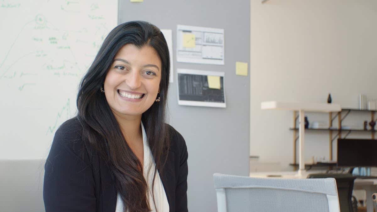 Reservations specialist smiling in an office during a client conversation